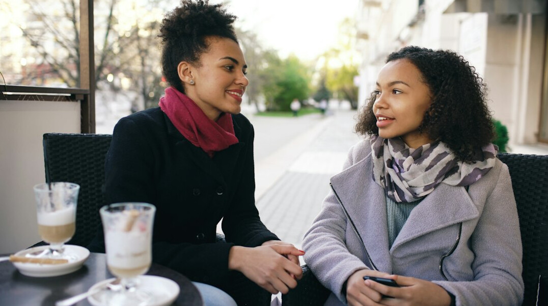 two people talking in cafe